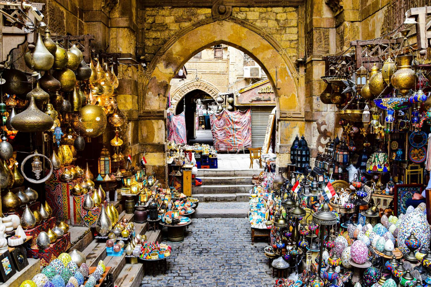 The arched gate of Khan el-Khalili, lined with brass lamps and lanterns